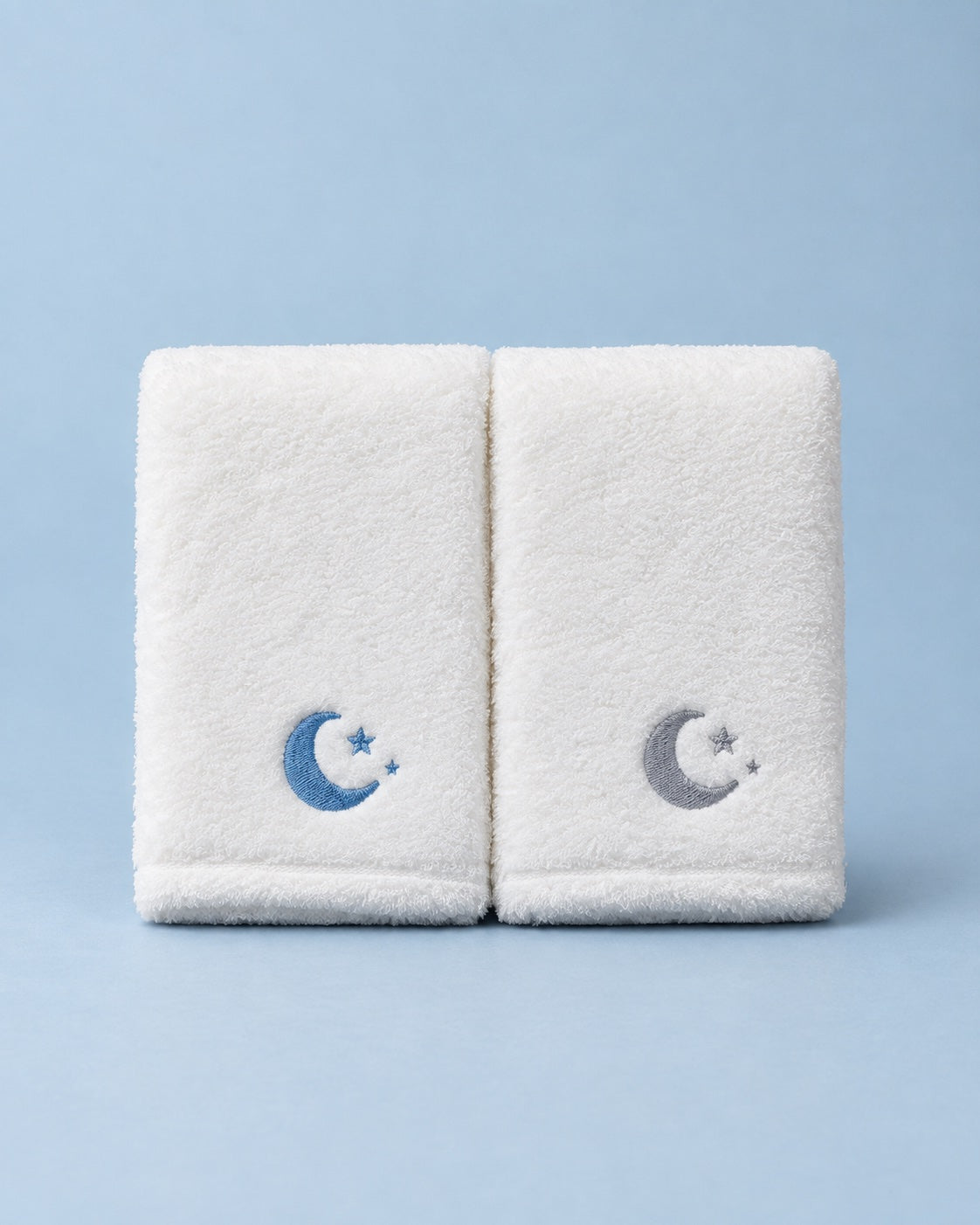 Two white Cloud towels with blue and gray lunar embroidery